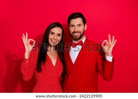 Photo portrait of attractive young couple show okey symbol valentine day wear trendy elegant clothes isolated on red color background