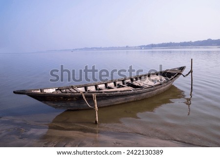 Landscape View of a wooden  boat on the bank of the Padma river in Bangladesh Royalty-Free Stock Photo #2422130389