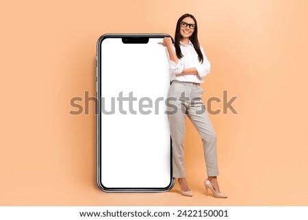 Full body size photo of young promoter businesswoman direct finger empty space look phone screen board isolated on beige color background
