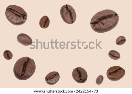 Falling coffee beans isolated on background. Flying defocused coffee beans. Used for cafe advertising, packaging, menu design