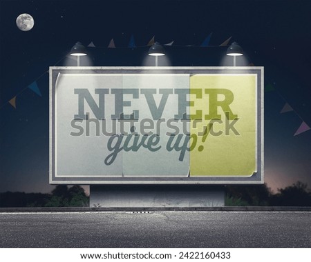 Inspirational and motivational advertisement on large vintage style billboard: never give up!