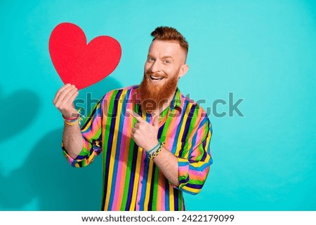 Photo of charismatic macho red hair with beard and mustache pointing finger valentine day postcard isolated on blue color background