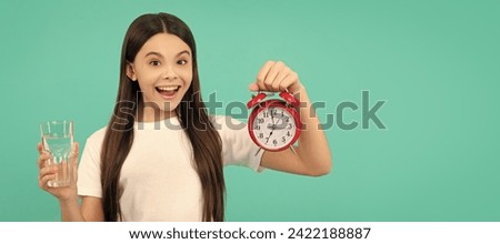 water balance in body. hydration vitality. drinking per day. be hydrated. kid hold glass and clock. Banner of child girl with glass of water, studio portrait with copy space. Royalty-Free Stock Photo #2422188887