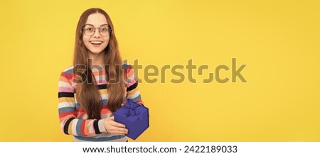 black friday discount. seasonal sales. happy teen girl in eyeglasses with box. Kid girl with gift, horizontal poster. Banner header with copy space.