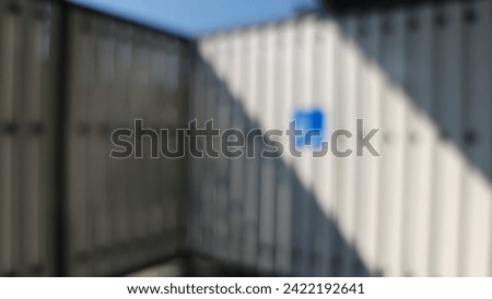 Blurred images light through the white wooden fence.