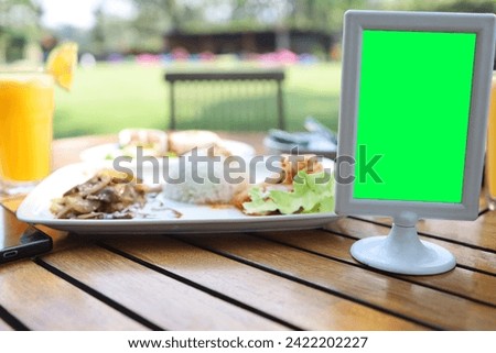 blank green screen on table, mockup of table numbers, billboard, chroma key and text space
