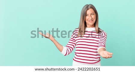 pretty middle age woman smiling happily with friendly and  offering and showing a concept