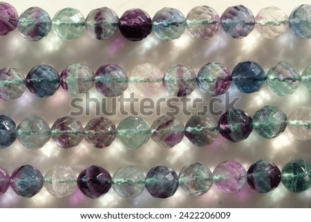 Faceted beads made of natural fluorite. Royalty-Free Stock Photo #2422206009