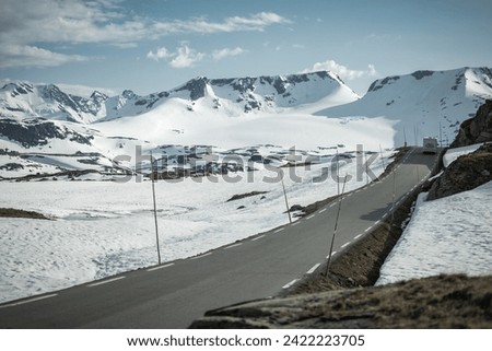 Class C Camper Van on a Norwegian Mountain Road During Early Summer Royalty-Free Stock Photo #2422223705