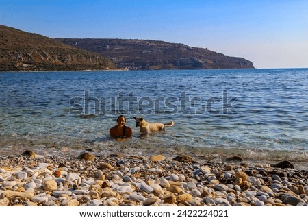 Young woman with her dog on Neo Itilo beach, Peloponnese, Grecce