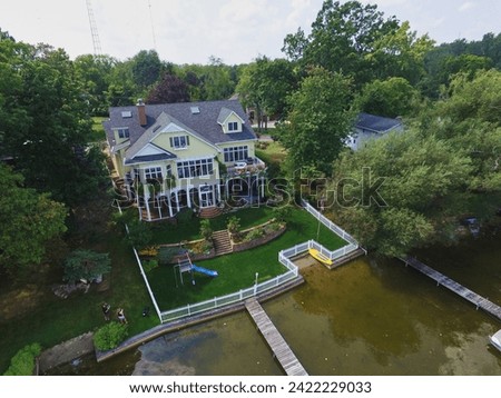Aerial View of Elegant Waterfront House with Manicured Lawn in Syracuse Royalty-Free Stock Photo #2422229033