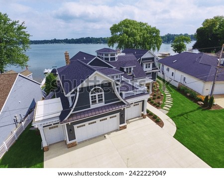 Aerial View of Luxury Lakeside Estate with Manicured Gardens Royalty-Free Stock Photo #2422229049