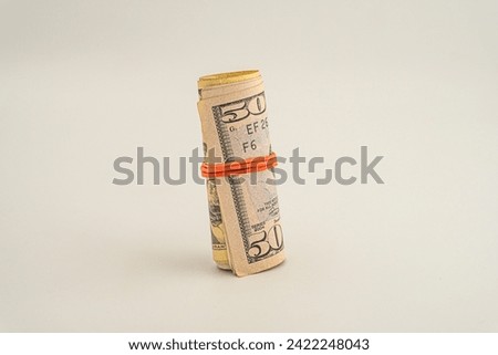 Banknotes of the United States dollar. Roll of fifty US dollars isolated on a white background. Dollar roll isolated on white background