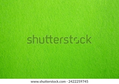 Felt fabric texture with visible fiber, toxic green color abstract pattern backdrop, close up