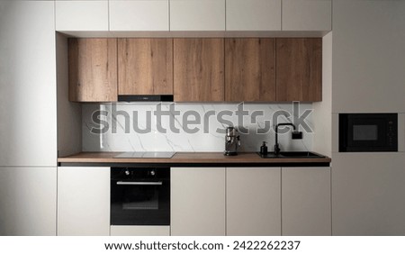 Modern built-in kitchen with appliances in a minimalist style Royalty-Free Stock Photo #2422262237