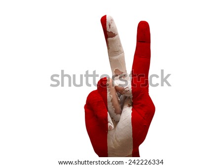 grunge flag painted hand making the V sign isolated over white background