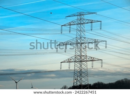 High voltage power lines along a road in Austria. Royalty-Free Stock Photo #2422267451