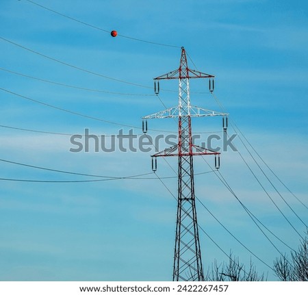 High voltage power lines along a road in Austria. Royalty-Free Stock Photo #2422267457