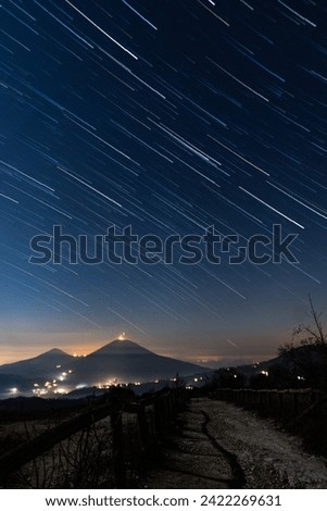 Star trails streaking across the sky above the Euganean Hills, with Monte Vendevolo visible in the distance to the northwest.