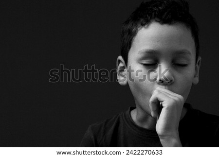 little boy sucking thumb on black background with people stock image stock photo