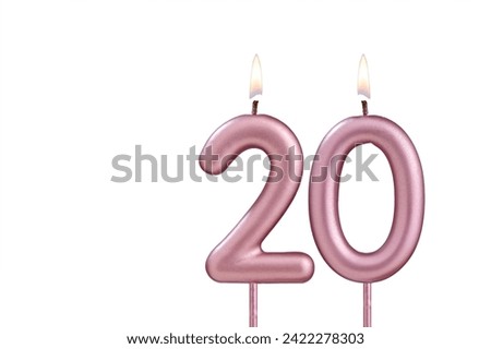 Lit birthday candle - Candle number 20 on white background Royalty-Free Stock Photo #2422278303