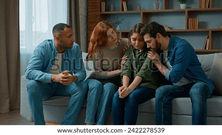 Desperate sad woman cry complain life problem diverse women and men colleagues buddies support stressed girl multiracial team sit on psychological therapy group meeting at home give help calm friend Royalty-Free Stock Photo #2422278539