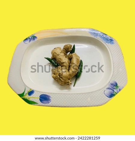 Ginger, green chillies, yellow background - a colorful picture with spice ingredients on bright backdrop.🫚