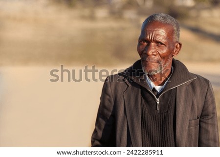 old african man standing on a dirt road in a sunny day Royalty-Free Stock Photo #2422285911