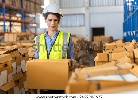 Portrait engineer woman shipping order detail check goods and supplies on shelves with goods background inventory in factory warehouse.logistic industry and business export	