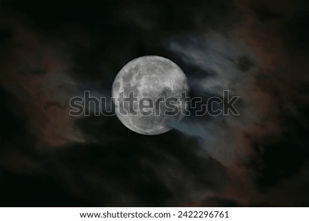 The full moon on a cloudy night, composite of 2 images exposure bracketed to expose the moon and the clouds.