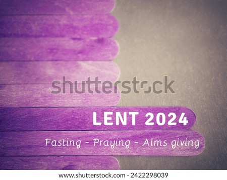 Lent Season,Holy Week and Good Friday Concepts. Lent 2024 fasting praying alms giving text on wooden stick in purple colour background. Stock photo.