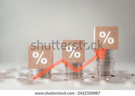 Interest rate finance and mortgage rates. Wood block with percentage sign on stack of coins and rise of arrow up, financial growth, interest rate increase, inflation, sale price and tax rise concept.