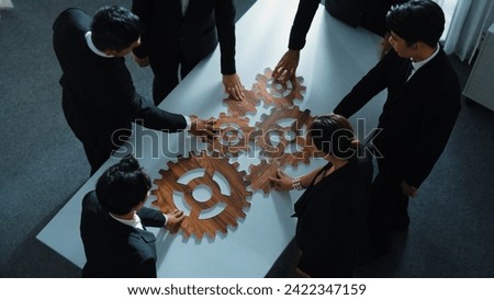 Top view of smart business people gather wooden cog together at meeting. Group of project manager helping and team working to solve problem at meeting room or workplace. Represent unity. Directorate.