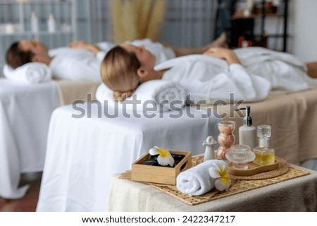 Aromatherapy massage on daylight ambiance or spa salon composition setup with focus decor and spa accessories on blur woman enjoying blissful aroma spa massage in resort or hotel background. Quiescent Royalty-Free Stock Photo #2422347217