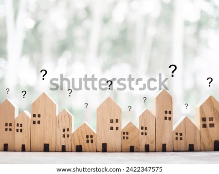 Miniature house with question mark icons.The concept of choosing suitable house for planning living in the future. Real estate Royalty-Free Stock Photo #2422347575