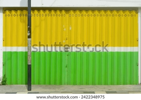 a yellow and green iron harmonica door