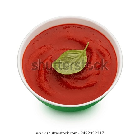Bowl of tomato soup isolated on white background, top view