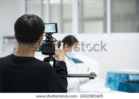 Videographer working with his camera.Professional media production recording at studio.Filming with professional camera concept.
