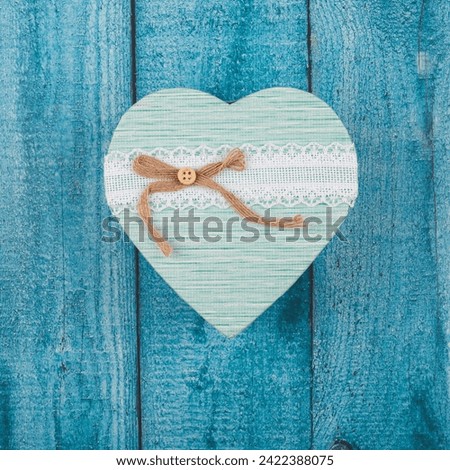 Valentine's Day card - gift box in the shape of a heart on a blue wooden background