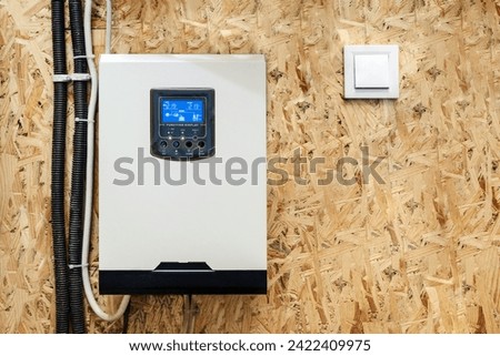 Solar Inverter Hybrid isometric System Controller with Switch. Home Battery Energy Storage located in Garage Wall. Royalty-Free Stock Photo #2422409975