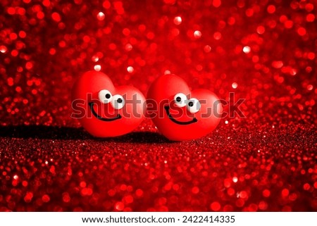 Two smiling heart characters radiate joy on a sparkling red backdrop, creating the perfect Valentine's Day card.