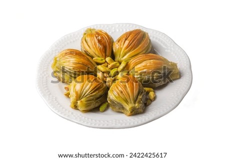 Turkish Midye Baklava ( Mussel Shape Baklava ) with green pistachio Powder and Butter Cream. Conceptual of Islamic Feasts. Royalty-Free Stock Photo #2422425617
