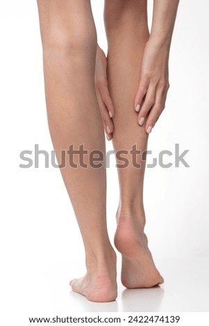 Slim legs on isolated white background. Royalty-Free Stock Photo #2422474139