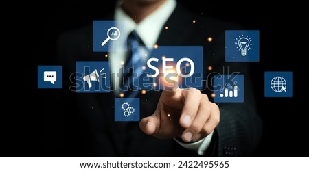 SEO concept, Businessman touch virtual SEO icons to analyze SEO search engine optimization for promoting ranking traffic on website and optimizing your website to rank in search engines.
