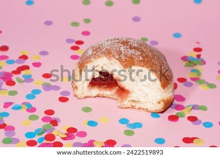 traditional festive german carnival sweets Berliner Krapfen Pfannkuchen in front of a colourful background