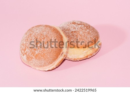 traditional festive german carnival sweets Berliner Krapfen Pfannkuchen in front of a colourful background