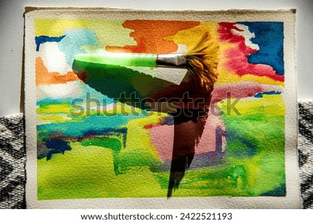 Paintbrush and paint can on abstract colorful watercolor background.
