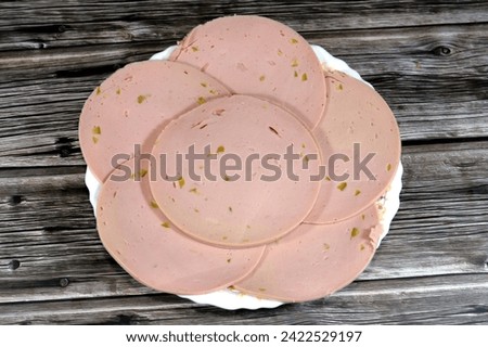Lunch meats, cold cuts, luncheon cooked sliced cold delicatessens deli chicken meats, precooked or cured meats that are sliced and served cold made of chicken breast and loaf with cuts of olive in it Royalty-Free Stock Photo #2422529197