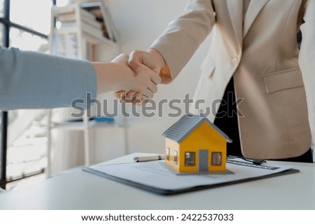 real estate broker manager hand shake to customer after signing contract for buying house, investment, buy and sell house concept, Real estate professionals and clients discussing home purchases, 