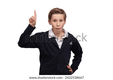 A schoolboy boy raised his finger up. A concept is an idea. Royalty-Free Stock Photo #2422538667